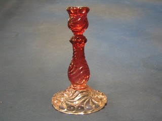 A red pressed glass candlestick, base marked  Baccarat Depote