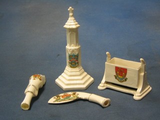 An Arcadia crested china model of a Gurkhas Kukri decorated Arms of City of Bristol, a crested model of a pigs trotter decorated Arms of Bolton Trotter, an Arcadia cradle decorated Arms of Folkestone, and an Arcadia crested model of Sherringham War Memorial decorated Arms of Sherringham (4)