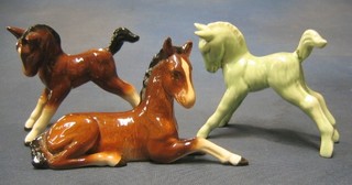 A Sylvac figure of a seated foal 7", do. standing foal 4" and a Sylvac figure of a green glazed foal 4" (tail f)