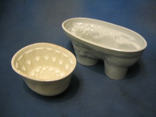 A Victorian white glazed pottery jelly mould in the form of a lion 10 1/2" and an oval white glazed jelly mould 7"