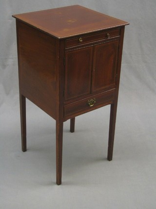 A Georgian inlaid mahogany night cabinet enclosed by double panelled doors above a drawer, raised on square tapering supports 16"