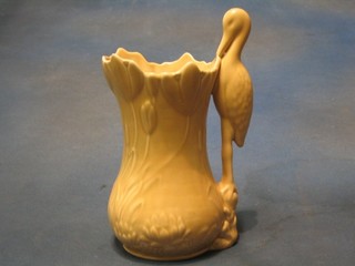 A Sylvac cream glazed jug, the handle in the form of a stork 10 