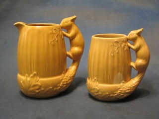2 Sylvac pottery jugs the handles in the form of squirrels (both f)