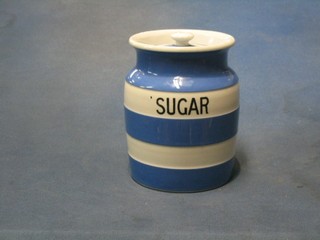 A circular blue and white striped T G Greener Cornish Kitchen ware storage jar marked Sugar, the base with green Cathedral mark