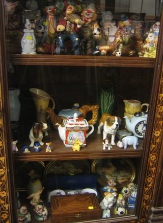 A collection of pottery figures of clowns, a Sylvac style green glazed vase, various 1930's pottery vases, figures of dogs etc