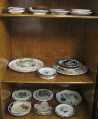 A large collection of decorative ashtrays, plates etc, etc,
