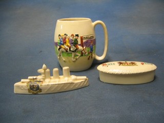 A Devonmoor Widdecombe Fair pottery tankard, a crested model of a battleship decorated Arms of Brighton, an oval crested pin tray decorated Arms of City of London and 2 Toby jugs (5)