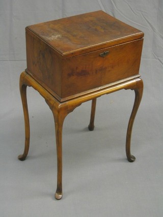 A 1930's Queen Anne style walnut sewing box with hinged lid, raised on cabriole supports 16"