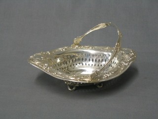 A pierced and embossed silver basket with swing handle 7"
