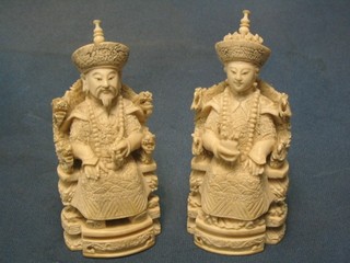 A pair of carved ivory figures of seated Emperor and Empress 5"  the base with carved seal mark,