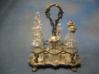 A Victorian silver plated 6 bottle cruet frame raised on panel supports together with 5 matching cut glass bottles