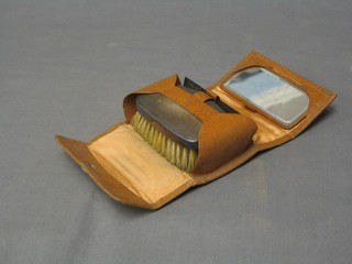 A gentleman's silver backed hairbrush and comb with leather carrying case