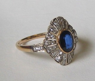 A lady's 18ct gold dress ring set a large oval cut sapphire surrounded by numerous diamonds