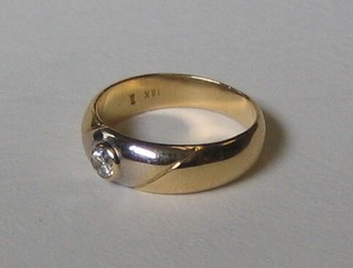 A lady's 18ct yellow and white gold band set a diamond