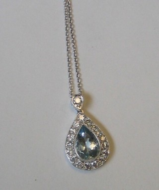 A lady's handsome 18ct gold aquamarine tear drop shape pendant supported by numerous diamonds (approx 0.71ct)