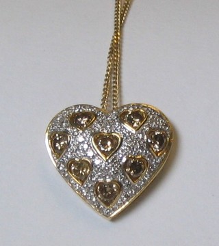 A lady's handsome 18ct pierced gold heart shaped pendant set 8 diamonds and surrounded by numerous diamonds, hung on a fine gold chain