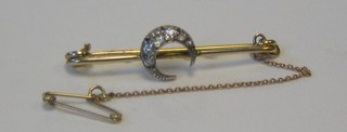 A lady's Edwardian gold bar brooch set a crescent moon set diamonds