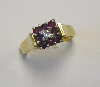A lady's 18ct gold dress ring set a diamond surrounded by 12 rubies