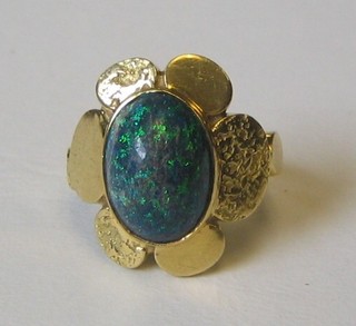 A lady's 18ct gold dress ring set a cabouchon cut opal coloured stone