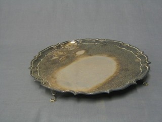 A silver plated salver with bracketed border