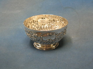 A circular embossed Victorian silver sugar bowl, raised on a  circular spreading foot London 1894, 6 ozs