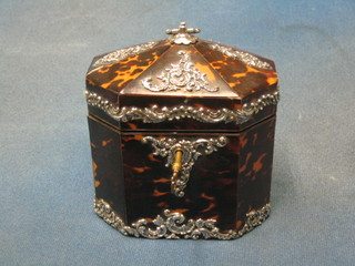 A handsome Georgian octagonal shaped tortoiseshell tea caddy with silver mounts throughout and hinged lid 5"