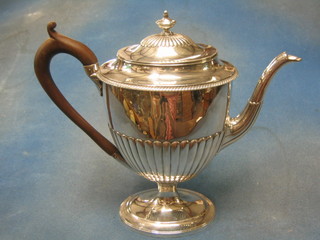 A handsome George III oval silver coffee pot with demi-reeded decoration, raised on an oval spreading foot, London 1804 with replacement beech handle, makers mark TERS, 40 ozs