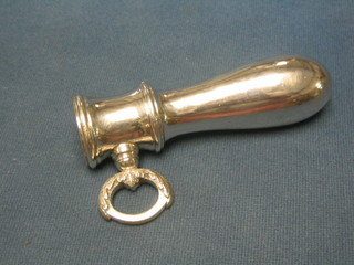 A silver plated ham bone clamp