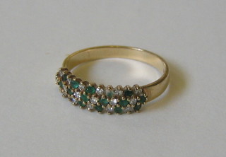 A lady's 9ct gold dress ring set emeralds and diamonds