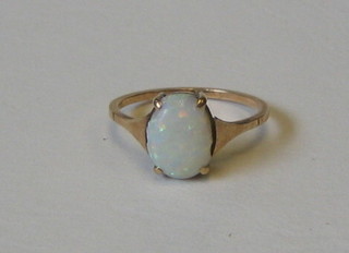 A lady's 9ct gold dress ring set an oval cabouchon cut opal