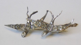 A lady's bar brooch in the form of 2 diving birds set white stones