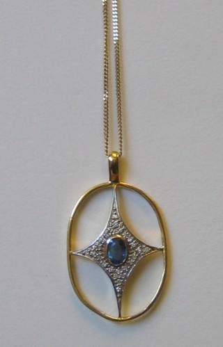A stylised 18ct yellow gold cross pendant, set a sapphire to the centre surrounded by numerous diamonds, hung on a gold chain