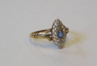 A lady's 18ct gold marquise shaped dress ring set a sapphire surrounded by numerous diamonds (approx 0.32ct)