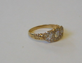 A lady's 18ct gold triple cluster ring (approx 0.68ct)
