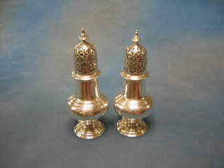 A pair of George III plain silver castors of baluster form, London 1784, 10 ozs