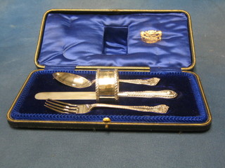 A handsome silver 4 piece christening set comprising knife, fork, spoon and napkin ring, cased
