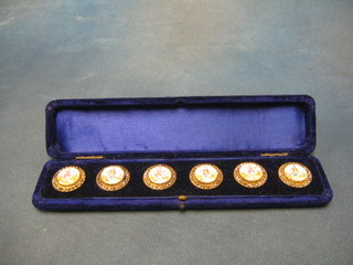 A set of 6 19th Century gilt metal buttons with polished steel studs, the centres enamelled figures in 18th Century costume, contained in a plush blue case