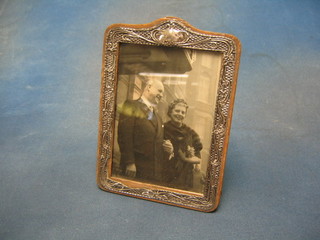An Edwardian embossed silver easel photograph frame Birmingham 1904 7" x 5" (torn and some holes)
