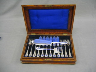A canteen of 25 silver plated fish knives and forks comprising 2 servers, 12 knives and 11 forks contained in an oak canteen box