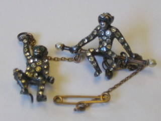 A silver brooch in the form of 2 monkeys set white stones