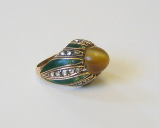 An Eastern gold and green enamelled dress ring set cabouchon tigers eye and diamonds