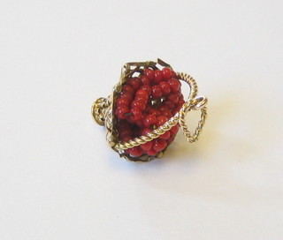 A high carat gold charm in the form of a basket of fruit set coral