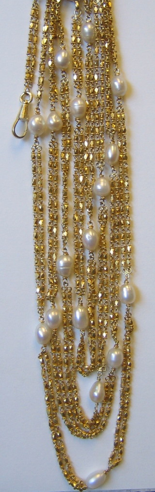 An Eastern 22ct gold chain, interspaced 20 pearls 66" long