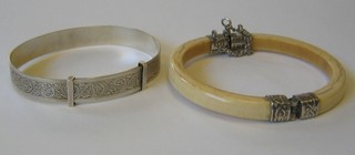 An Eastern ivory and silver bangle (f) together with a silver bangle (2)