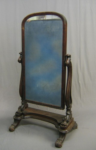 A Victorian arched plate cheval mirror contained in a mahogany swing frame 31"
