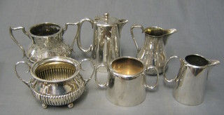 A silver plated hotelware teapot, twin handled sugar bowl and cream jug and 2 silver plated sugar bowls and a cream jug