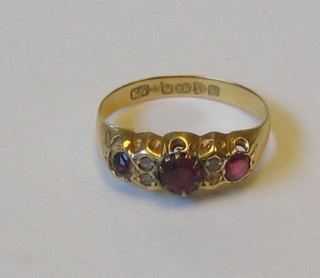 A lady's 18ct gold dress ring inset 3 red stones and 3 diamonds