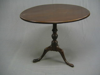 A Georgian circular mahogany snap top tea table, the top with some repairs raised on a gun barrel turned column and tripod feet (all feet with old repairs) 32"