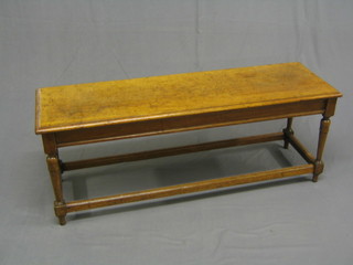 A rectangular 19th Century walnut bench raised on turned and block supports 48"