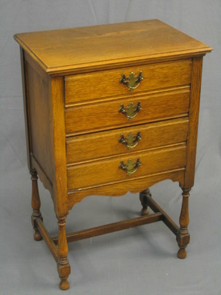 An Edwardian honey oak music chest of 4 long drawers 22"